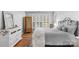Bedroom featuring hardwood floors, a wrought iron bed frame, and natural light from the window with plantation shutters at 10405 Scotland Ave, Indian Land, SC 29707