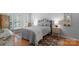 Bright bedroom with a wrought iron bed frame, hardwood floors, and plantation shutters for a cozy atmosphere at 10405 Scotland Ave, Indian Land, SC 29707