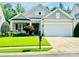 Charming single-Gathering home showcasing a well-manicured lawn and a two-car garage at 10405 Scotland Ave, Indian Land, SC 29707