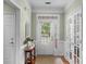 Welcoming foyer featuring a decorative table, natural light, and elegant trim details at 10405 Scotland Ave, Indian Land, SC 29707