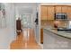 Hallway view of kitchen featuring stainless steel appliances and an entrance door at 10405 Scotland Ave, Indian Land, SC 29707