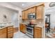 Kitchen shows stainless steel appliances, granite countertops, and stylish wood cabinetry at 10405 Scotland Ave, Indian Land, SC 29707