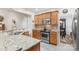 Granite counters highlight the stainless steel oven and cooktop in this home's kitchen at 10405 Scotland Ave, Indian Land, SC 29707