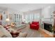 Bright living room boasts hardwood floors, a decorative fireplace, and natural light from large windows at 10405 Scotland Ave, Indian Land, SC 29707
