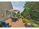 Enjoy this brick patio with dining set and umbrella, perfect for outdoor gatherings and relaxation at 10405 Scotland Ave, Indian Land, SC 29707
