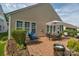 Brick patio with dining set, seating, and neat landscaping offers a relaxing outdoor space at 10405 Scotland Ave, Indian Land, SC 29707