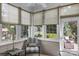Bright sunroom with many windows offering natural light and a view of the landscaped backyard at 10405 Scotland Ave, Indian Land, SC 29707
