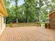 Large wooden deck perfect for outdoor entertaining with lush greenery surrounding at 1049 Regency Dr, Charlotte, NC 28211
