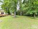Expansive backyard with mature trees and lush green lawn at 1049 Regency Dr, Charlotte, NC 28211