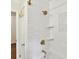 Bright bathroom featuring subway tiles, a shower, and gold hardware on fixtures at 1049 Regency Dr, Charlotte, NC 28211