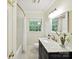 Elegant bathroom with a marble vanity, tiled floor, and tub/shower with subway tiles at 1049 Regency Dr, Charlotte, NC 28211