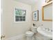Charming powder room featuring hexagonal tile, a pedestal sink, and natural light at 1049 Regency Dr, Charlotte, NC 28211