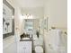 Charming bathroom with granite countertop vanity, decorative gold hardware, and stylish fixtures at 1049 Regency Dr, Charlotte, NC 28211