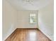 Cozy bedroom featuring hardwood floors and a window to bring in plenty of natural light at 1049 Regency Dr, Charlotte, NC 28211