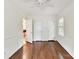 Well-lit bedroom with hardwood floors, windows, and access to another room and a closet at 1049 Regency Dr, Charlotte, NC 28211