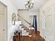 Inviting foyer with hardwood floors, chandelier, staircase, and elegant decor at 1049 Regency Dr, Charlotte, NC 28211