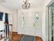 Bright foyer with decorative sidelights, hardwood floors, and a classic chandelier at 1049 Regency Dr, Charlotte, NC 28211