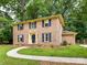 Charming brick home with blue shutters and a well-manicured front yard at 1049 Regency Dr, Charlotte, NC 28211
