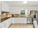 Well-lit kitchen with white cabinets, stainless steel appliances, and granite countertops at 1049 Regency Dr, Charlotte, NC 28211