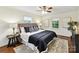 Comfortable main bedroom with a ceiling fan, side tables, and stylish patterned pillows on the bed at 1049 Regency Dr, Charlotte, NC 28211