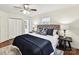 Relaxing main bedroom with hardwood floors, a ceiling fan, and a tufted headboard on the bed at 1049 Regency Dr, Charlotte, NC 28211