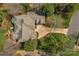 Aerial view of a luxury home with a well-manicured lawn, driveway, and lush landscaping at 10508 Old Wayside Rd, Charlotte, NC 28277