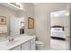 Bright bathroom with a white vanity, mirror, and a door open to the bedroom for a private and accessible layout at 10508 Old Wayside Rd, Charlotte, NC 28277