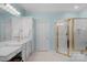 Bright bathroom with a white vanity, gold fixtures, and a glass enclosed shower in a well-maintained home at 10508 Old Wayside Rd, Charlotte, NC 28277