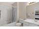Clean bathroom with white tile, a combined shower-tub, and a white vanity with a mirror for a functional space at 10508 Old Wayside Rd, Charlotte, NC 28277