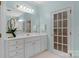 Light-filled bathroom with white cabinets, gold hardware, and a large mirror reflecting the well-maintained interior at 10508 Old Wayside Rd, Charlotte, NC 28277