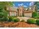 Beautiful two-story brick home with manicured lawn, mature trees and two car garage at 10508 Old Wayside Rd, Charlotte, NC 28277