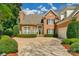 Lovely two-story brick home with manicured lawn, mature trees and welcoming curb appeal at 10508 Old Wayside Rd, Charlotte, NC 28277