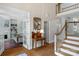 Elegant foyer featuring hardwood floors, staircase, and views into a sitting room at 10508 Old Wayside Rd, Charlotte, NC 28277