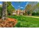 A spacious brick home featuring a lush front lawn and meticulously maintained landscaping at 10508 Old Wayside Rd, Charlotte, NC 28277