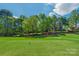 Scenic view of a pristine golf course tee box, showcasing lush greenery under a bright blue sky at 10508 Old Wayside Rd, Charlotte, NC 28277