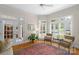 Inviting living room area with large windows, plantation shutters and comfortable seating at 10508 Old Wayside Rd, Charlotte, NC 28277