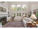 Bright and spacious living room featuring tall windows, fireplace and hardwood flooring at 10508 Old Wayside Rd, Charlotte, NC 28277