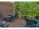 Inviting brick patio with wrought iron furniture and lush greenery, ideal for relaxing outdoors at 10508 Old Wayside Rd, Charlotte, NC 28277