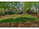 A brick home surrounded by trees and shrubbery, set upon a green, landscaped lot at 10508 Old Wayside Rd, Charlotte, NC 28277