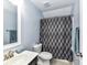 Neutral bathroom with a patterned shower curtain and single vanity at 10800 Alabaster Dr, Davidson, NC 28036