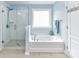 Bright bathroom featuring a glass shower, soaking tub, and modern fixtures at 10800 Alabaster Dr, Davidson, NC 28036