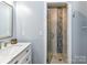 Modern bathroom with glass-enclosed shower, stylish tiling, and updated vanity at 10800 Alabaster Dr, Davidson, NC 28036