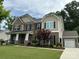 Well-manicured lawn and beautiful brick and siding exterior create a welcoming curb appeal at 10800 Alabaster Dr, Davidson, NC 28036