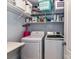 Functional laundry room with washer, dryer, and shelving at 10800 Alabaster Dr, Davidson, NC 28036