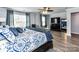 Bright and airy main bedroom with plush bedding, hardwood floors, and a cozy sitting area at 10800 Alabaster Dr, Davidson, NC 28036