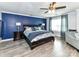 Spacious main bedroom featuring a king-size bed with a blue accent wall and ample natural light at 10800 Alabaster Dr, Davidson, NC 28036