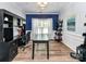 Stylish home office with custom built-ins, designer paint, and ample natural light at 10800 Alabaster Dr, Davidson, NC 28036