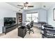 Comfortable office space featuring a ceiling fan, large desk, and TV at 10800 Alabaster Dr, Davidson, NC 28036