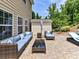 Comfortable outdoor seating area with stylish wicker furniture on a spacious brick patio at 10800 Alabaster Dr, Davidson, NC 28036