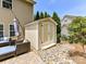 Well-maintained storage shed with double doors, situated on a stone foundation in the backyard at 10800 Alabaster Dr, Davidson, NC 28036
